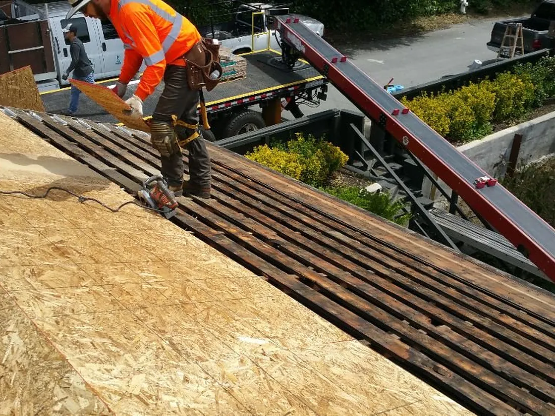 Franco Roofing crew at work on fresh plywood roof decking