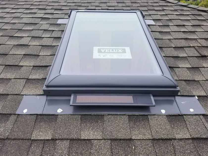 Velux skylight set into a shingle roof